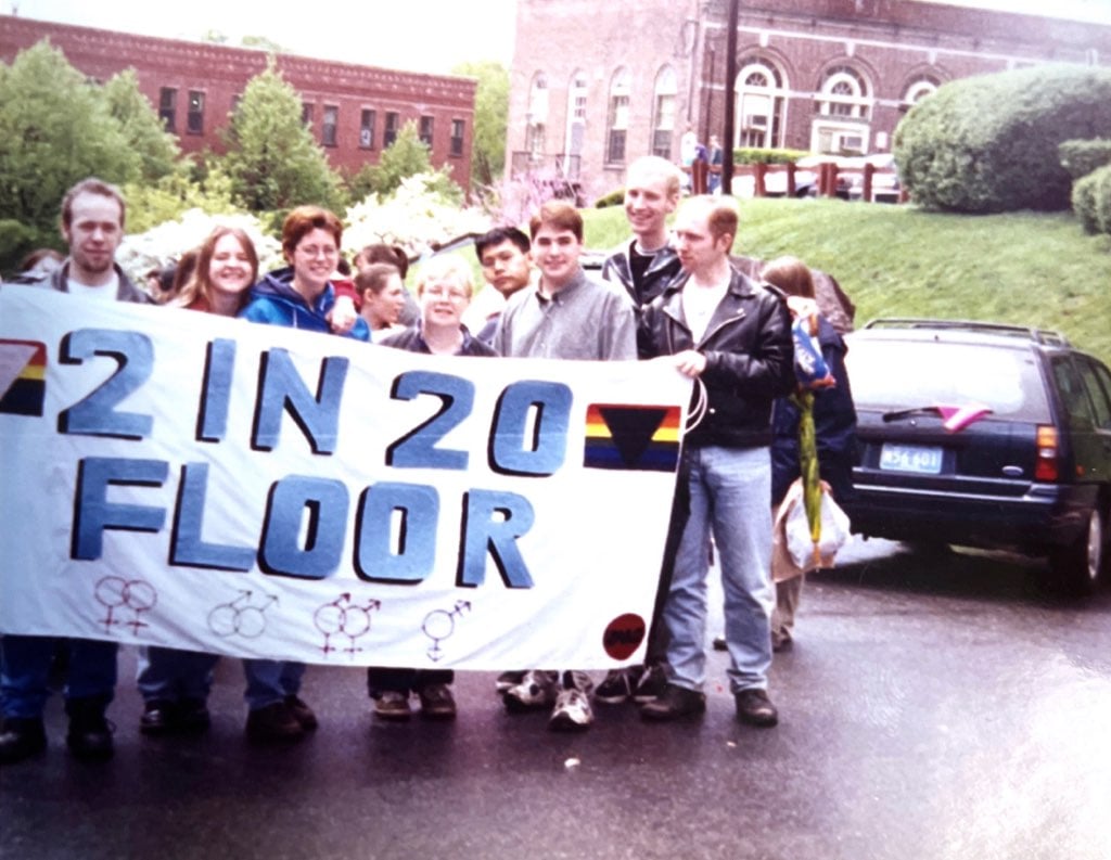 people holding 2 in 20 banner